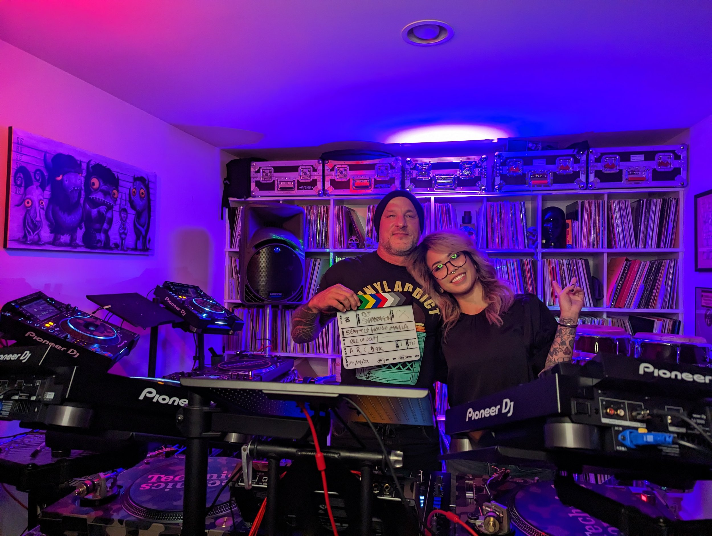 Interview setup in DJ studio with colorful wall art and professional lighting