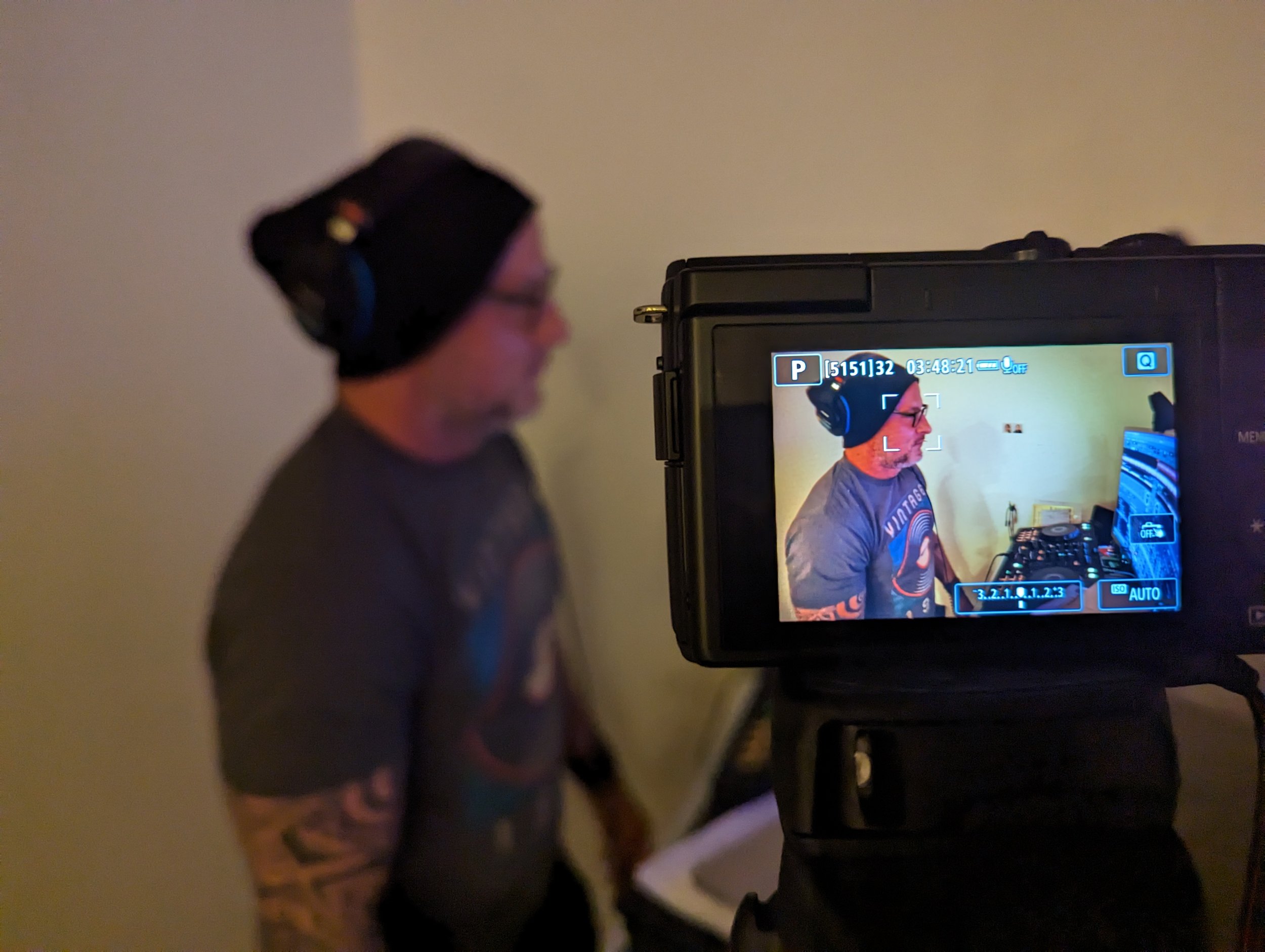 Behind the scenes of recording setup with mobile phone camera mount and DJ equipment