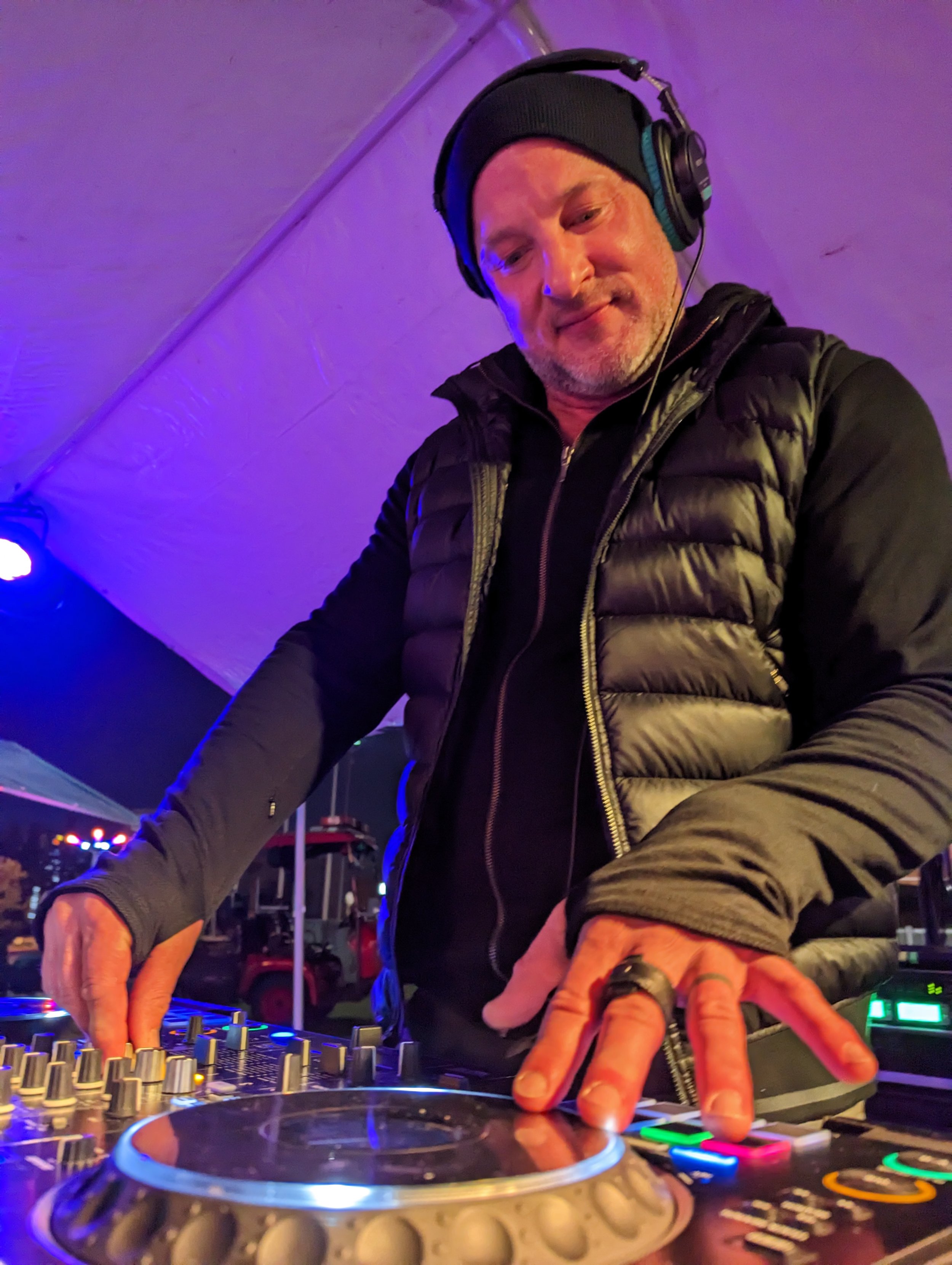 Two DJs posing with Seattle House Mafia merchandise and DJ equipment