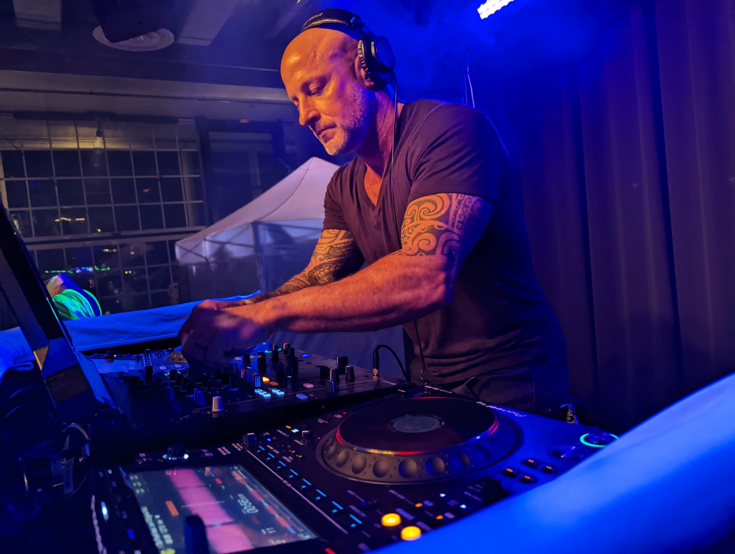 Close-up of DJ hands on Pioneer CDJ mixer during performance