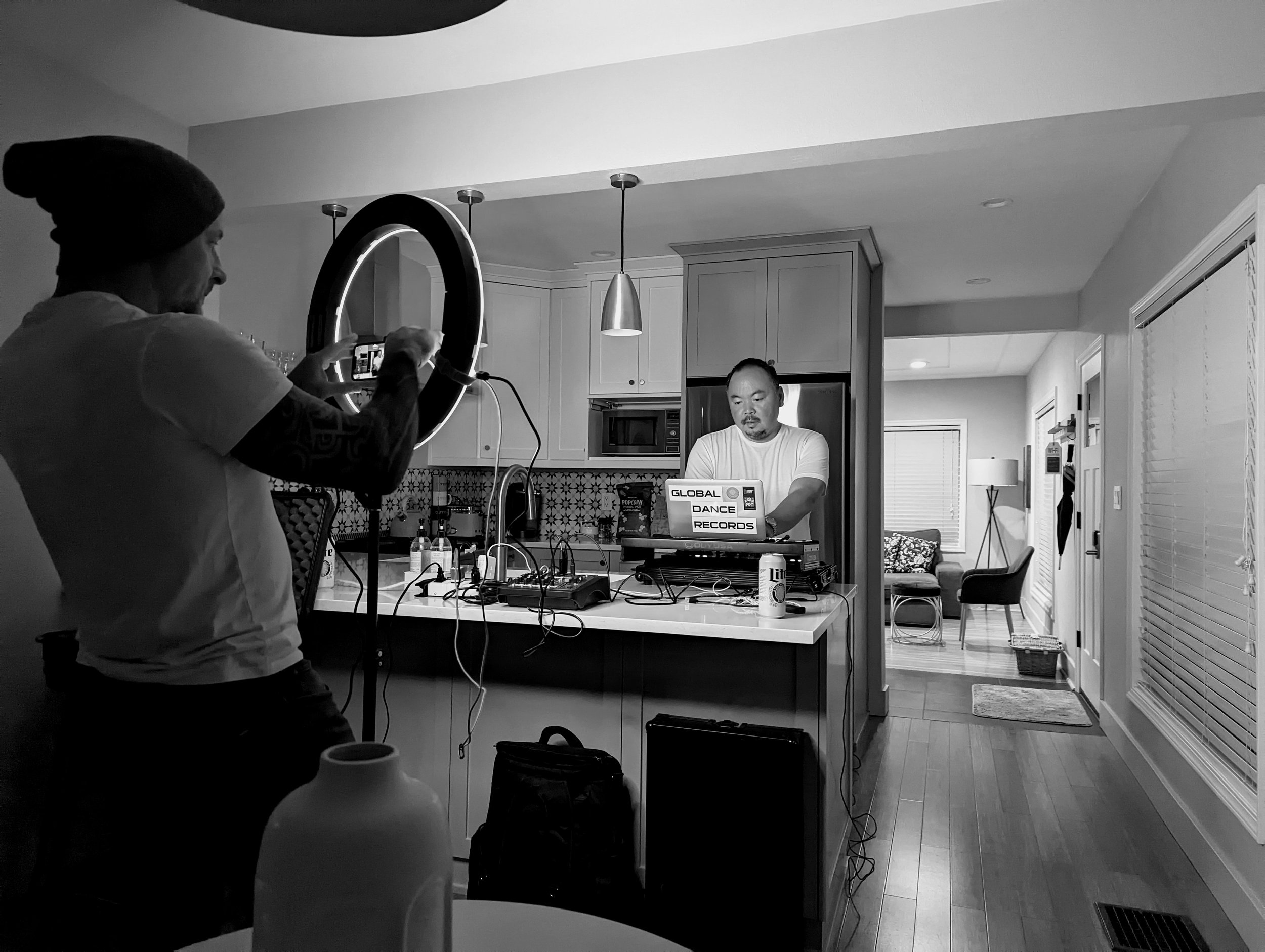 Black and white photo of DJ and crowd interaction at a nightclub