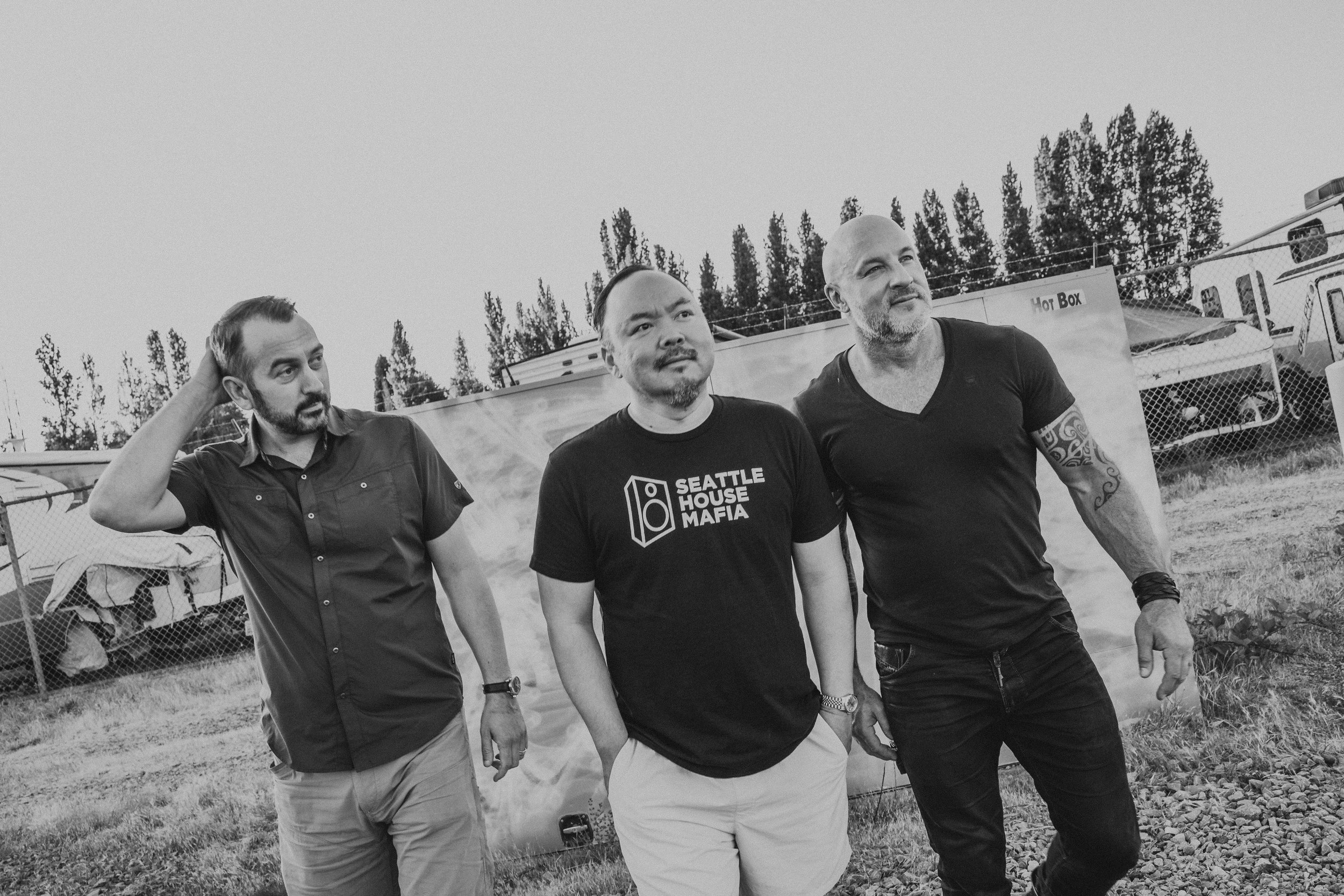 Behind the scenes black and white photo of DJ streaming setup in a kitchen with ring light