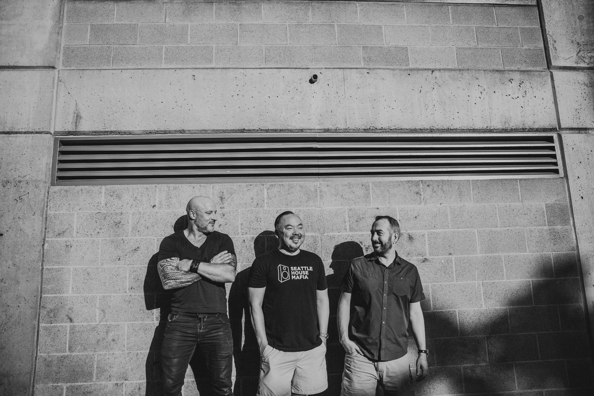 Energetic crowd dancing with DJ booth in foreground